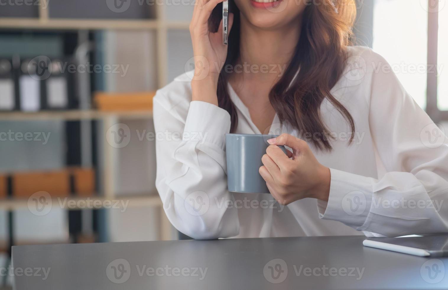 Marketing, Financial, Accounting, Planning, businesswomen uses a mobile phone to contact a customer to inform her of the company is business partnership. photo