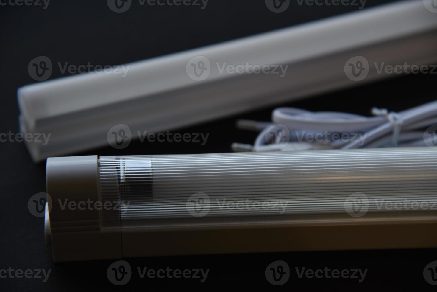 LED lamp on a black background. Lighting device. photo