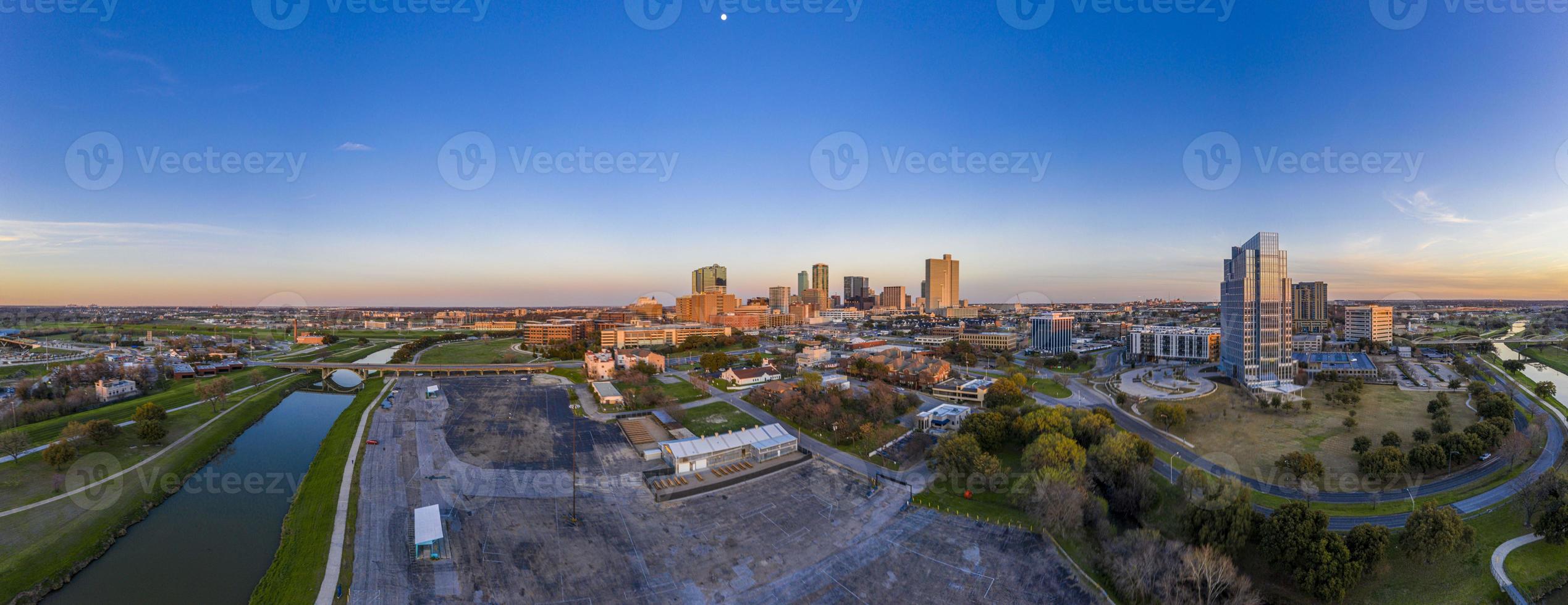 Aerial panorama picture of the Fort Worth skyline at sunset from west direction with sun reflections photo