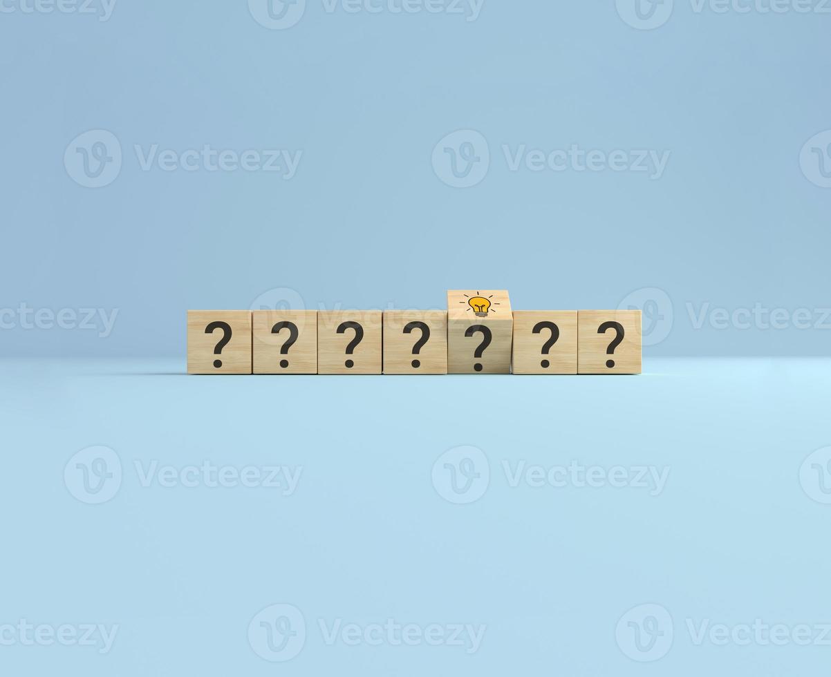 Concept creative idea and innovation. Flip over wooden cube block with question sign and light bulb icon. photo