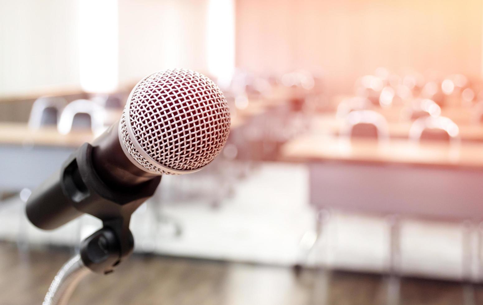 Microphone on abstract blurred of speech in seminar room photo