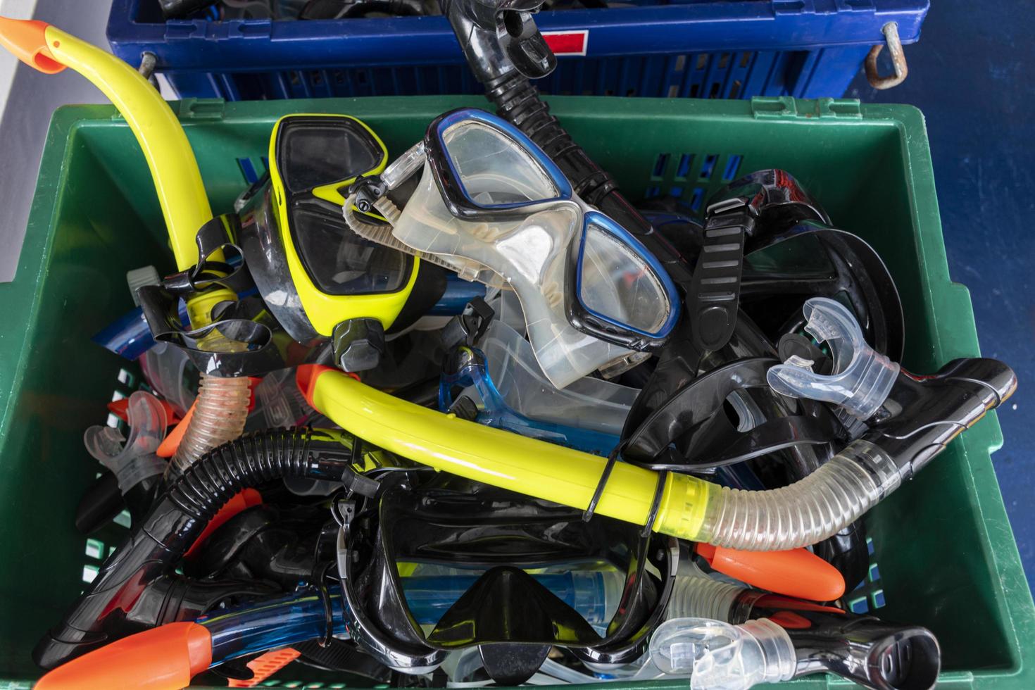 Colorful snorkel mask in plastic crate. photo