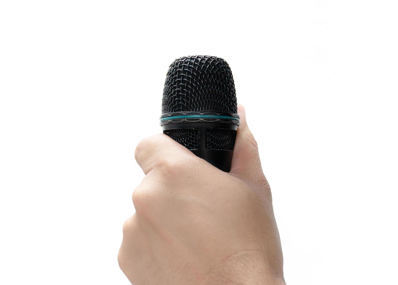 Hand holding a microphone isolated on white background photo