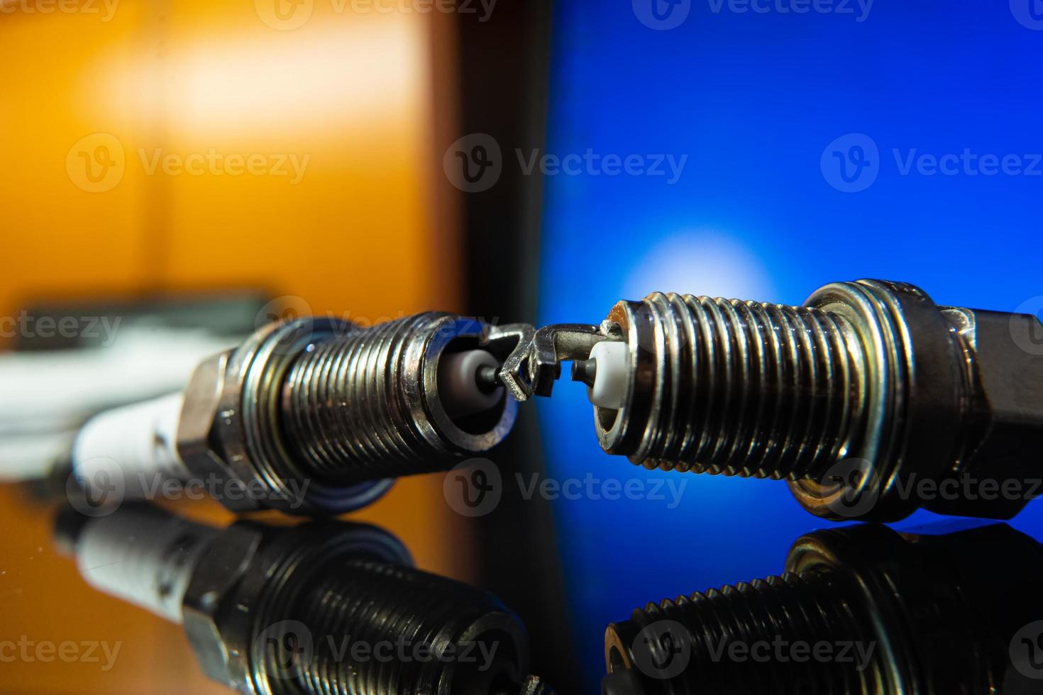 macrophoto of spark plugs on a blue background photo