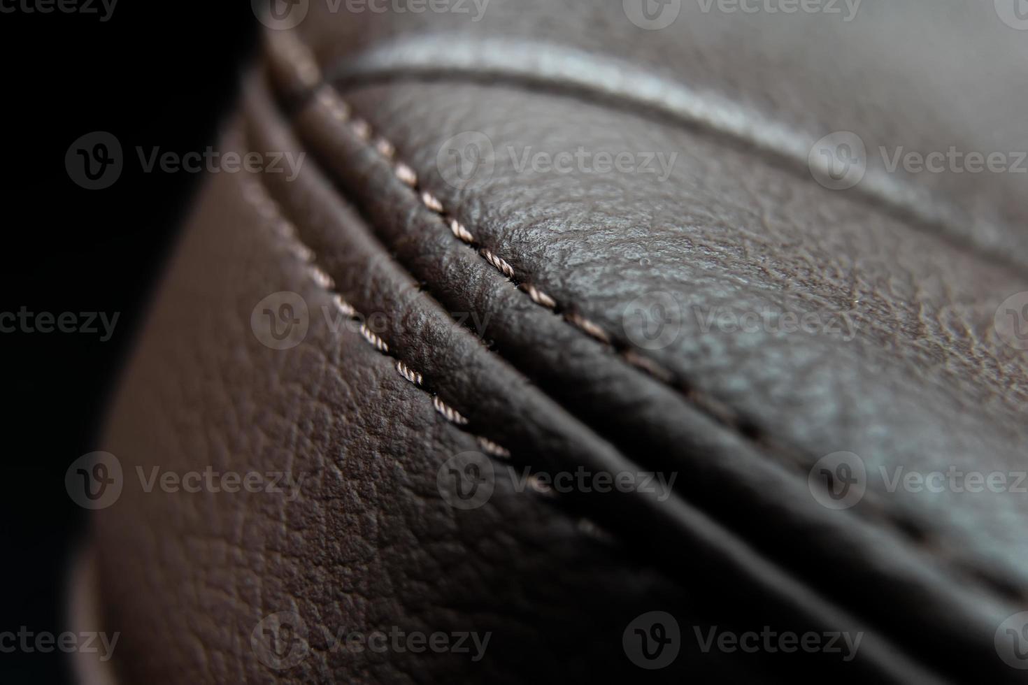 beautiful smooth seam in the leather upholstery of the car seat close-up photo