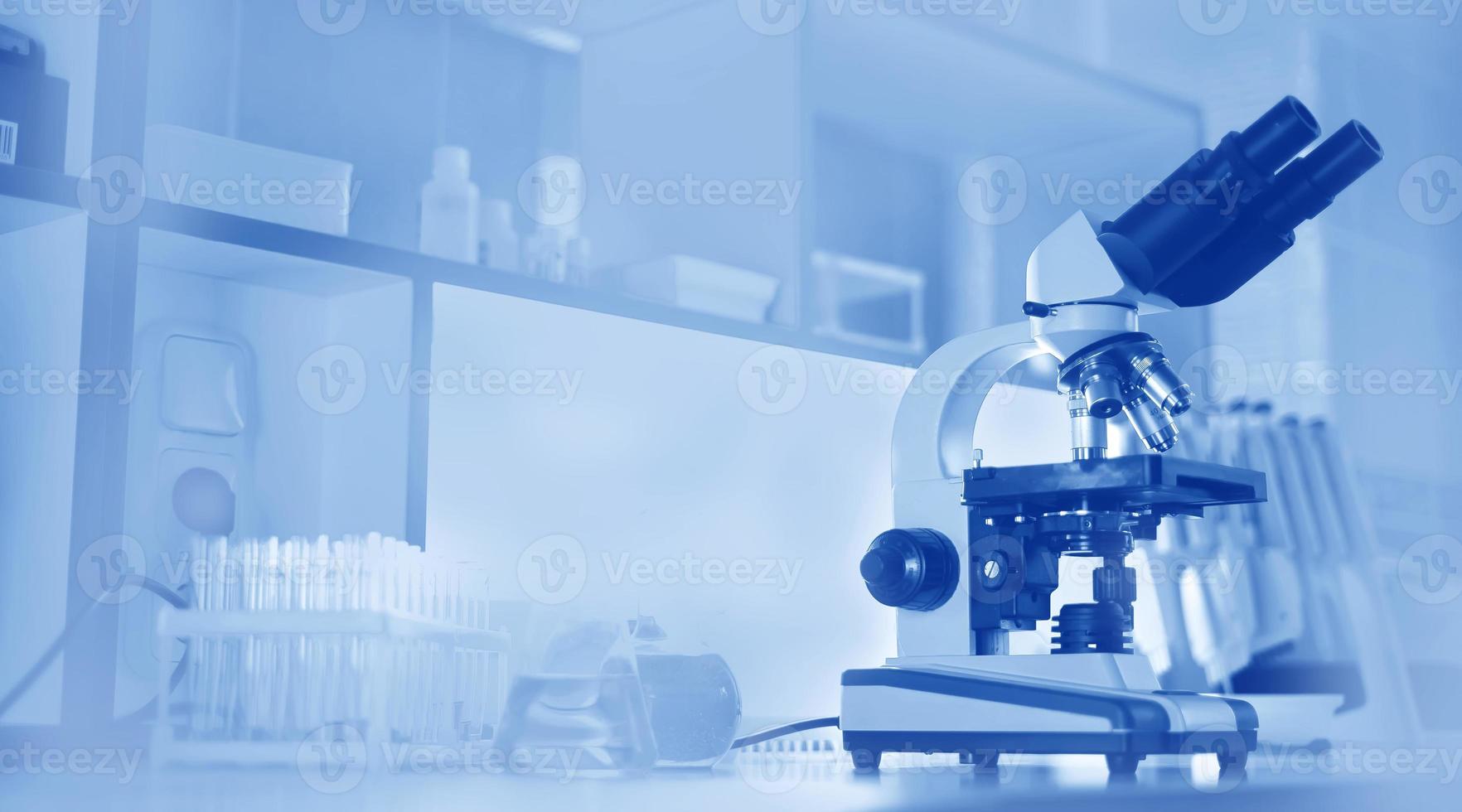 microscope and test tubes on the background of the laboratory. photo