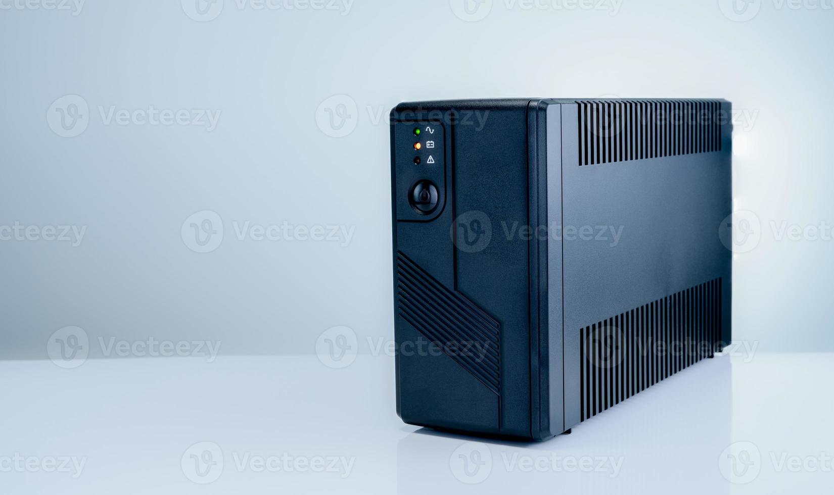 Uninterruptible power supply on white background. Backup Power UPS with battery. UPS with stabilizer for home PC. UPS inverter. Equipment for computer system at office for security. Power protection. photo