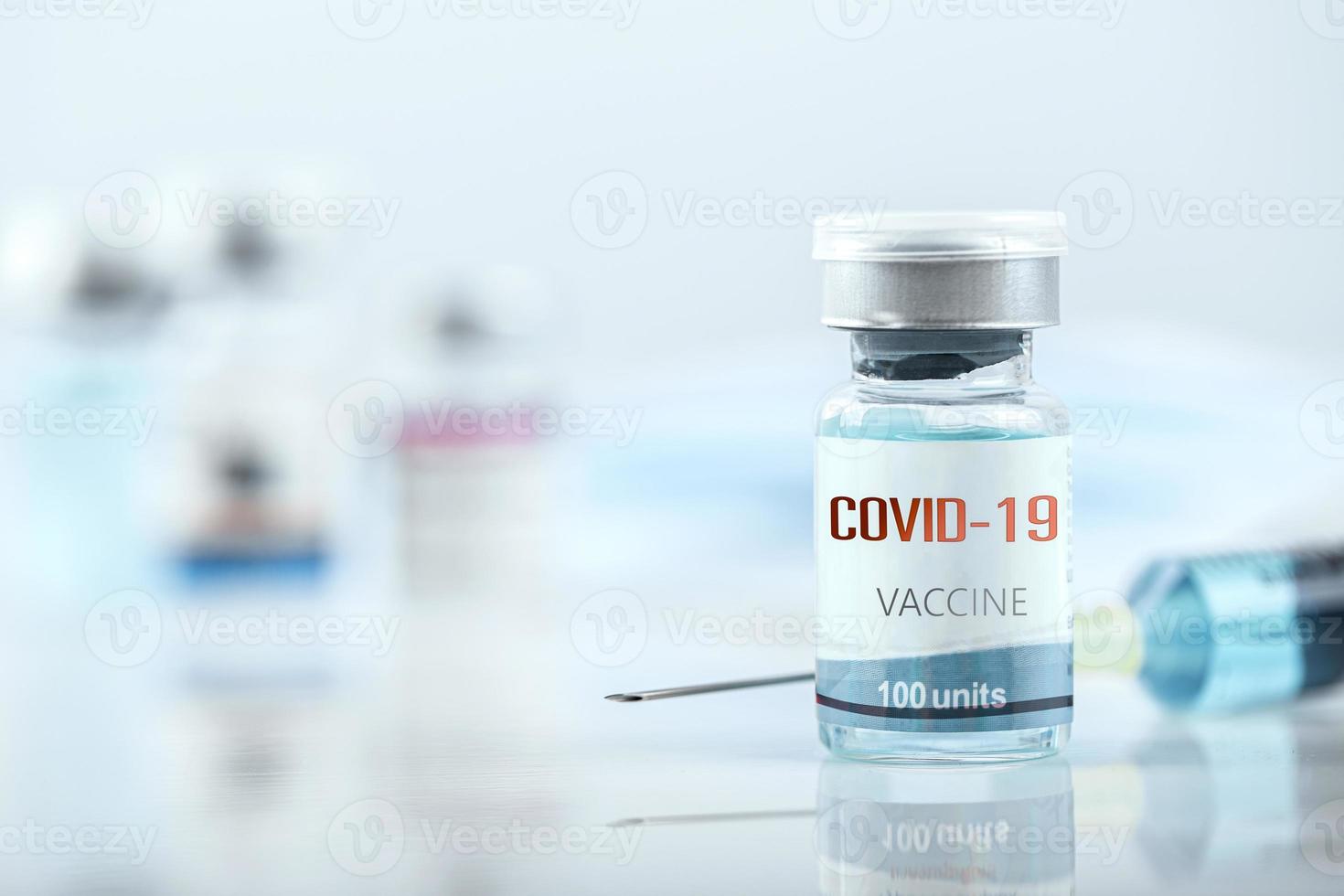 Blue vaccine jar bottle and syringe injection for treatment from corona virus infection and build immunity to viruses Covid-19 , Healthcare And Medical concept. photo