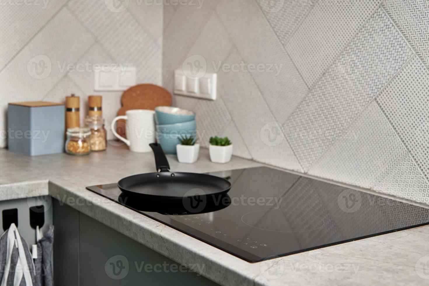 Induction stove with cooking pan on it. Modern kitchen appliance photo