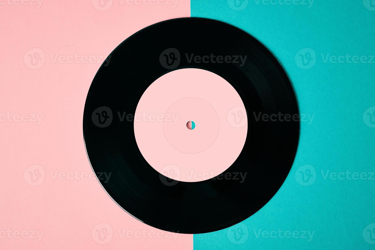 Old retro vinyl disc on colored background photo