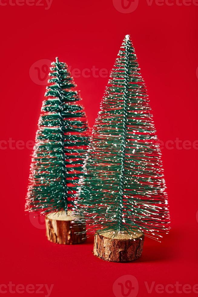 Merry Christmas and Happy New Year composition with christmas tree on red background photo