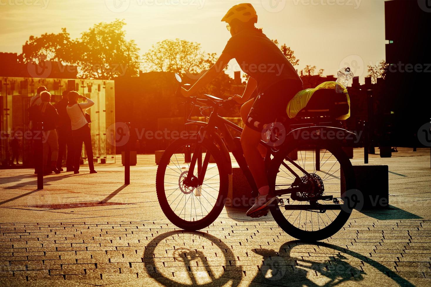 Woman ride on sport bicycle at city street photo