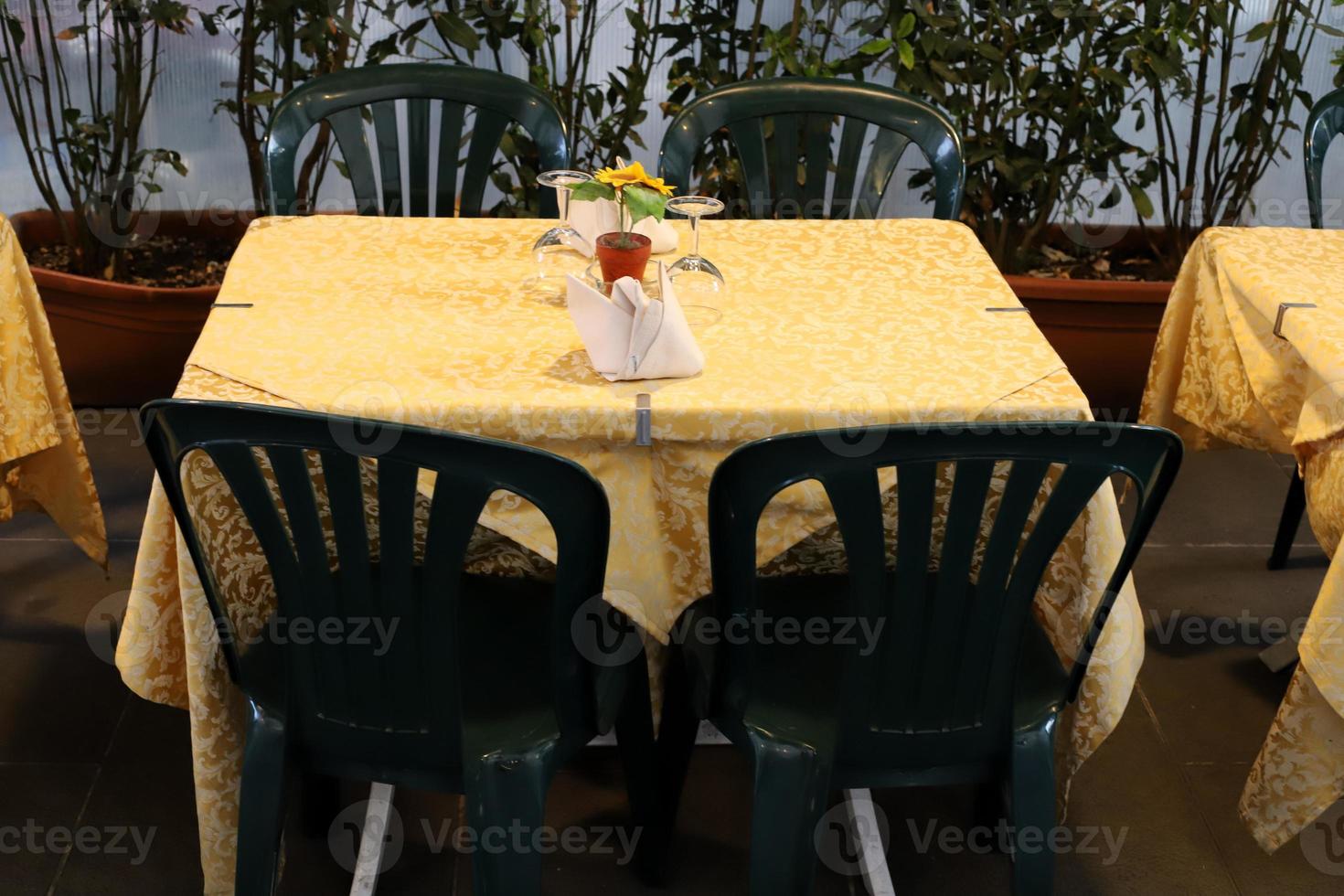 Chair and table in a cafe in a city park near the sea. photo