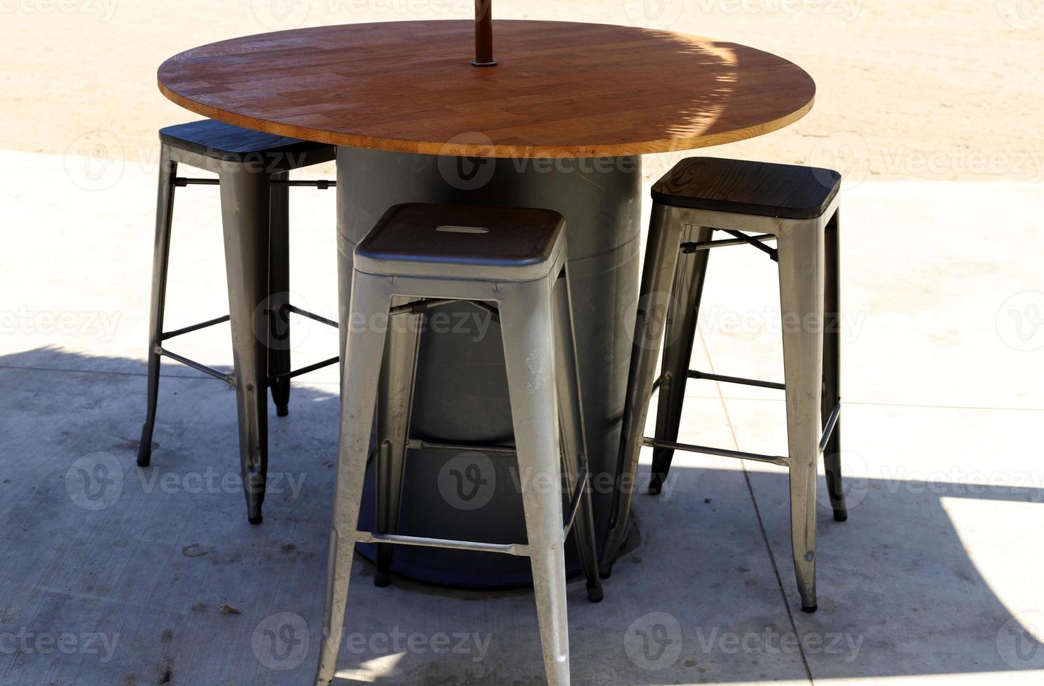 Chair and table in a cafe in a city park near the sea. photo
