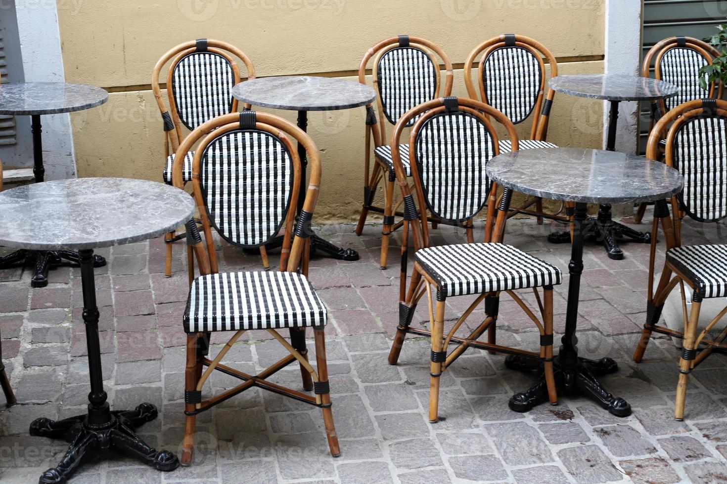 Chair and table in a cafe in a city park near the sea. photo