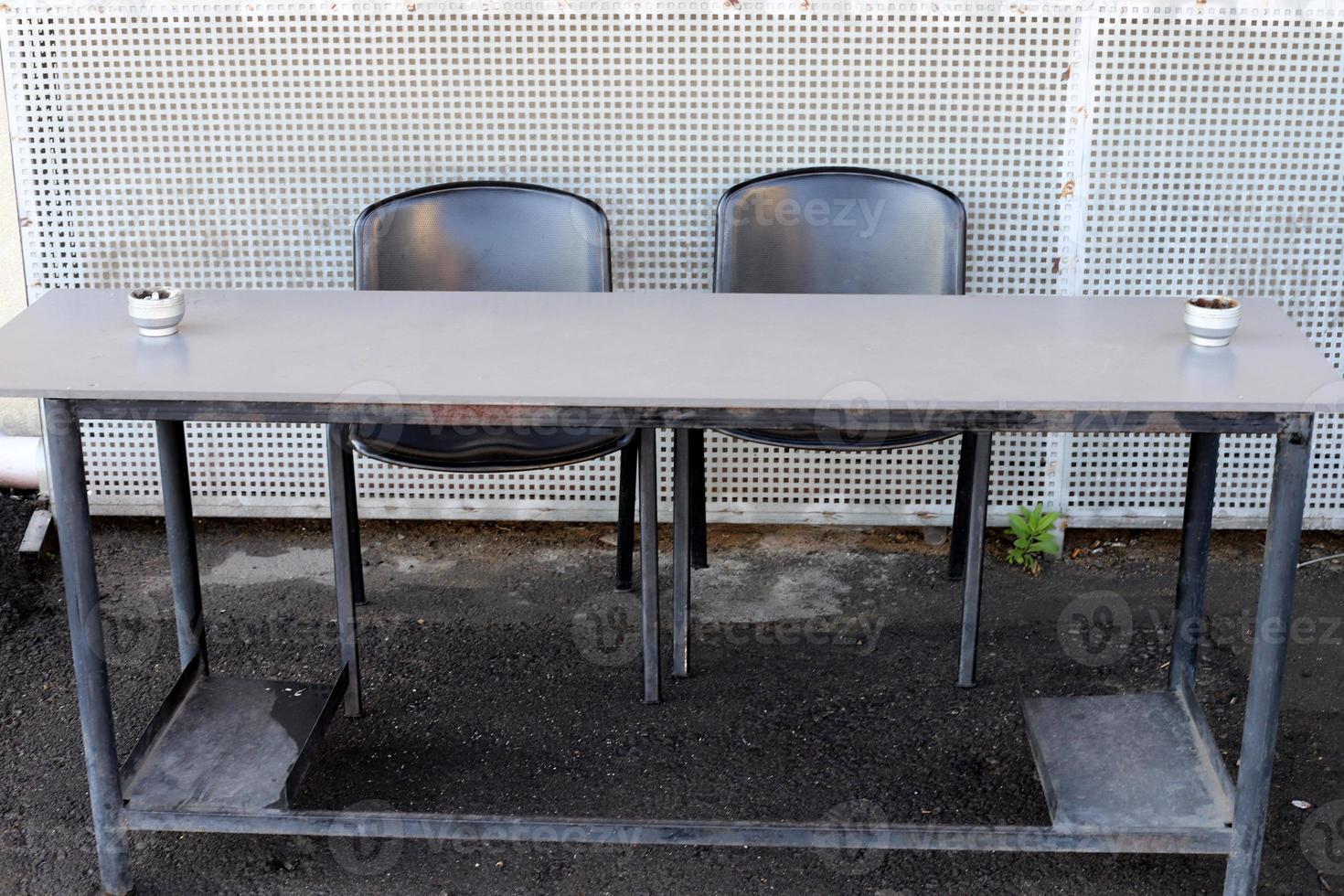 Chair and table in a cafe in a city park near the sea. photo