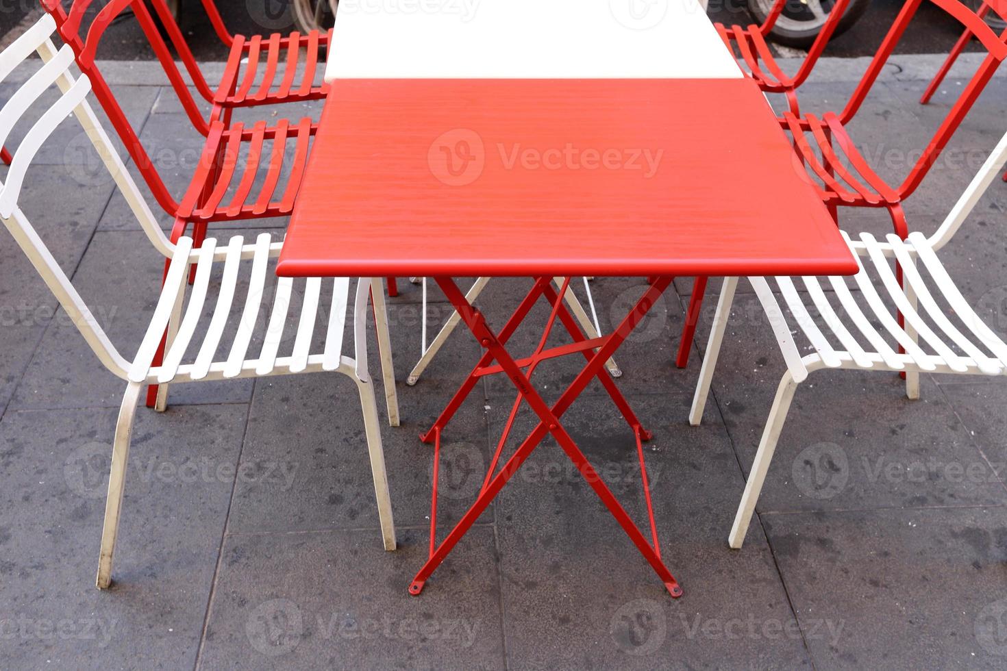 Chair and table in a cafe in a city park near the sea. photo
