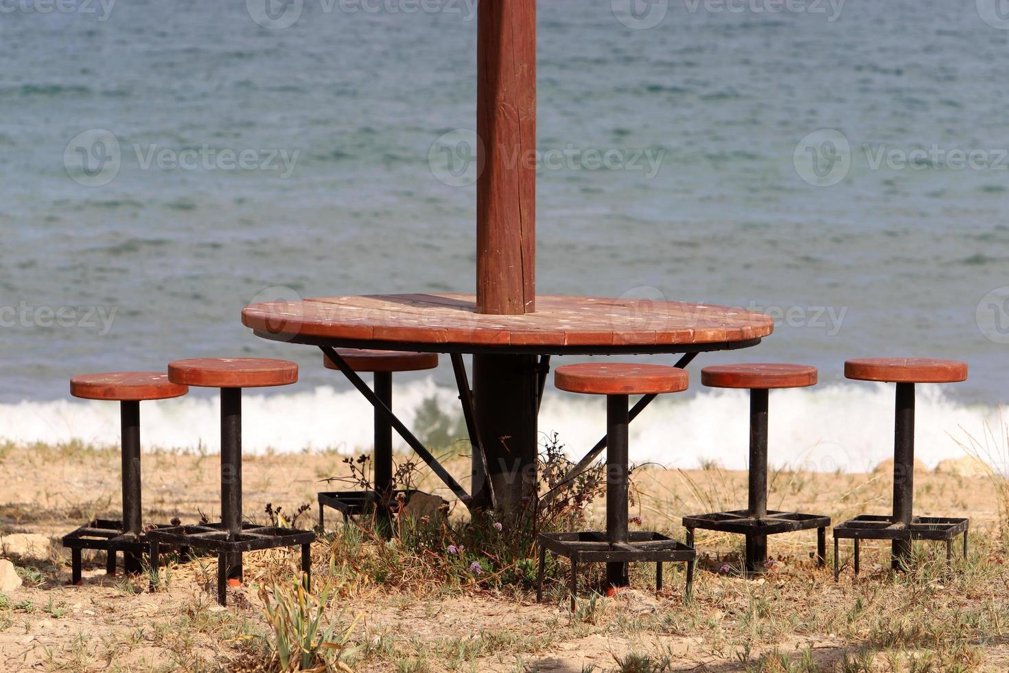 Chair and table in a cafe in a city park near the sea. photo