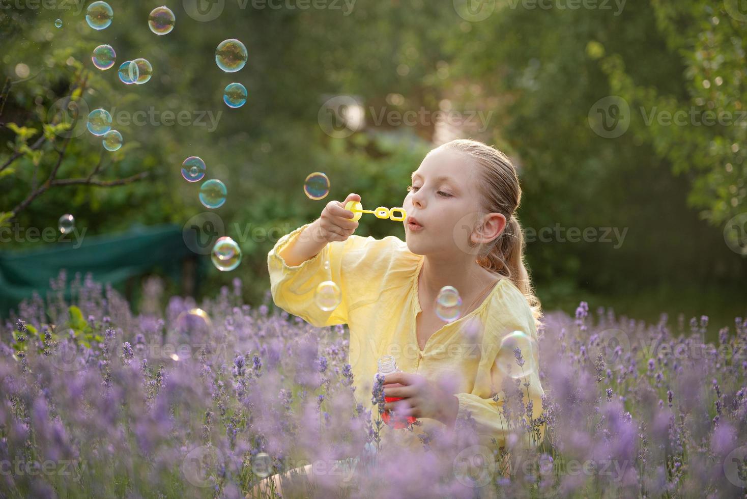 Beautiful little girl in a field with lavender. photo