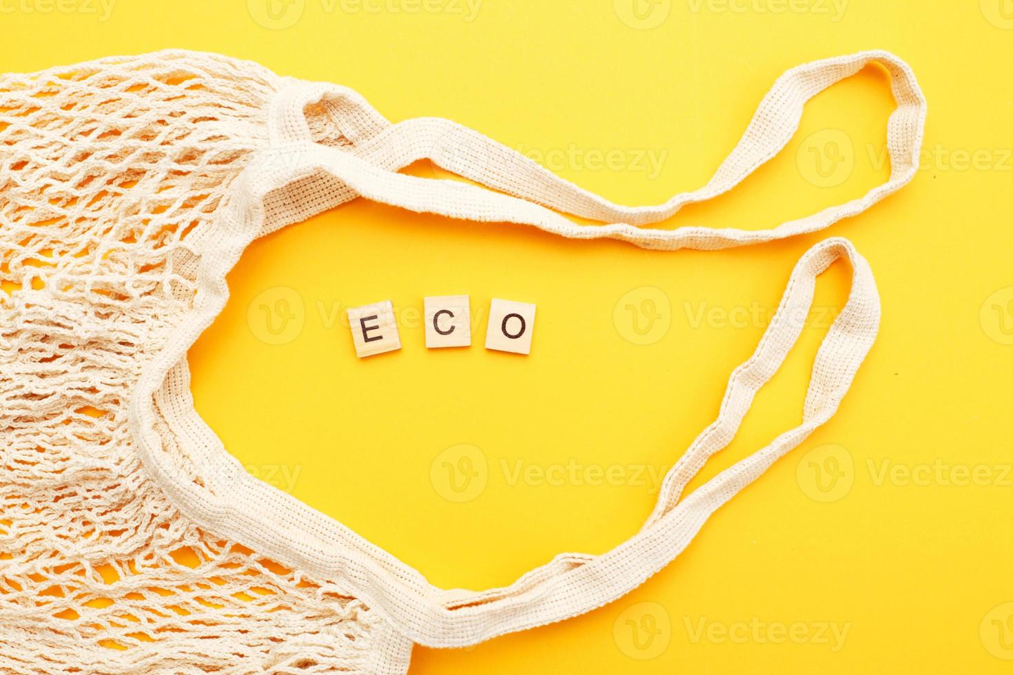 empty beige reusable string shopping bag on orange background. plastic free photo