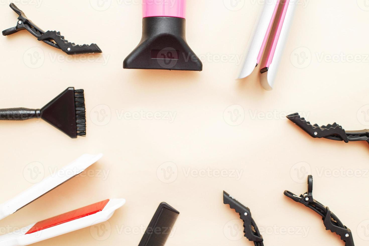 various hairdressing tools like hair dryer, comb on a beige background. beauty salon concept photo