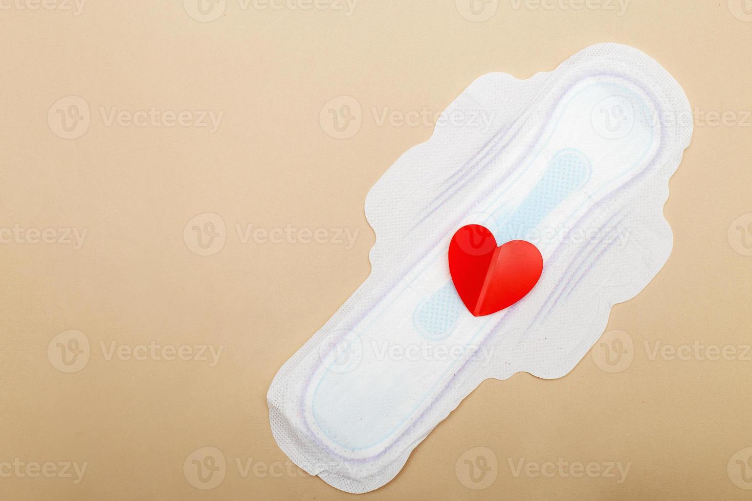 Women's pad on a beige background with red heart photo