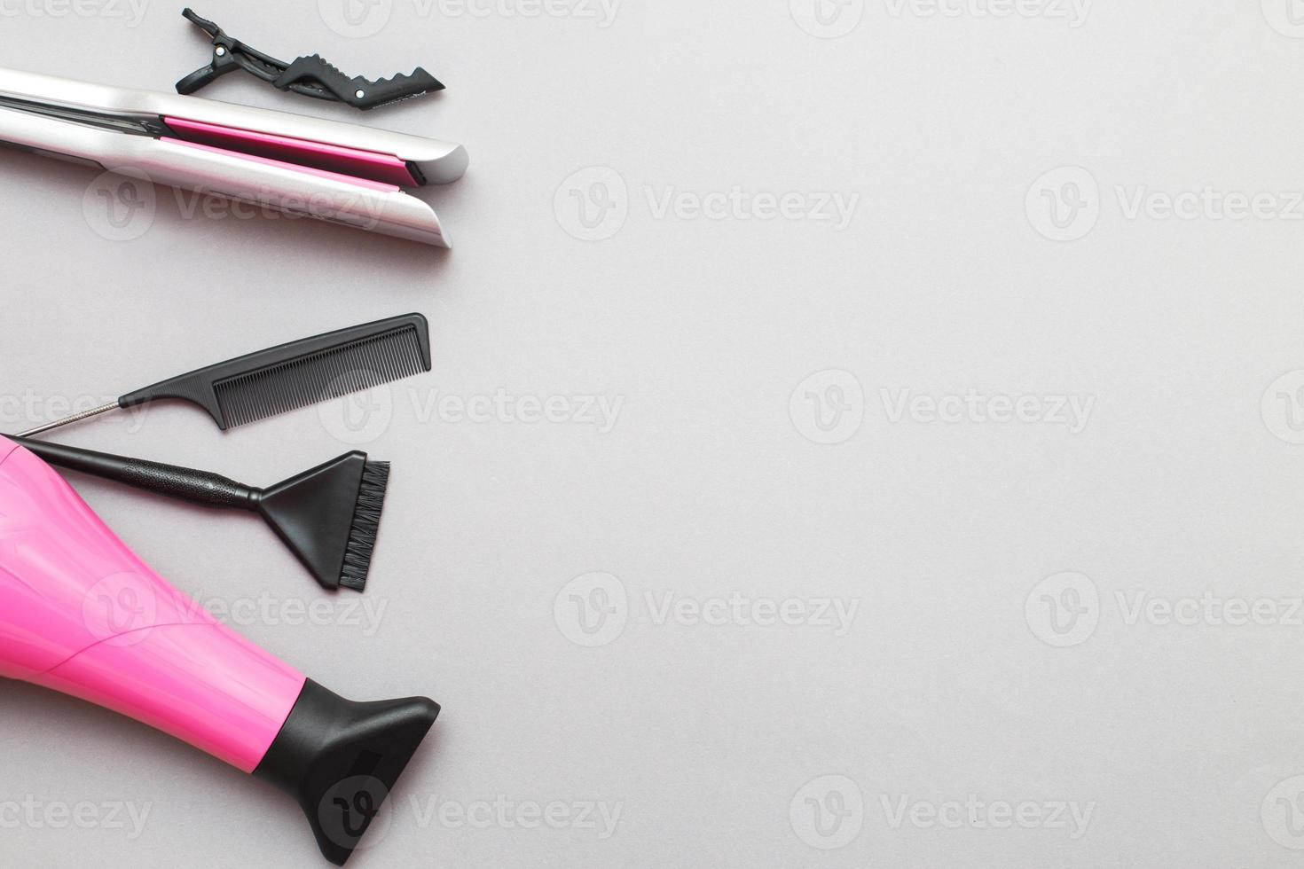 various hairdressing tools like hair dryer, comb on a gray background. beauty salon concept photo