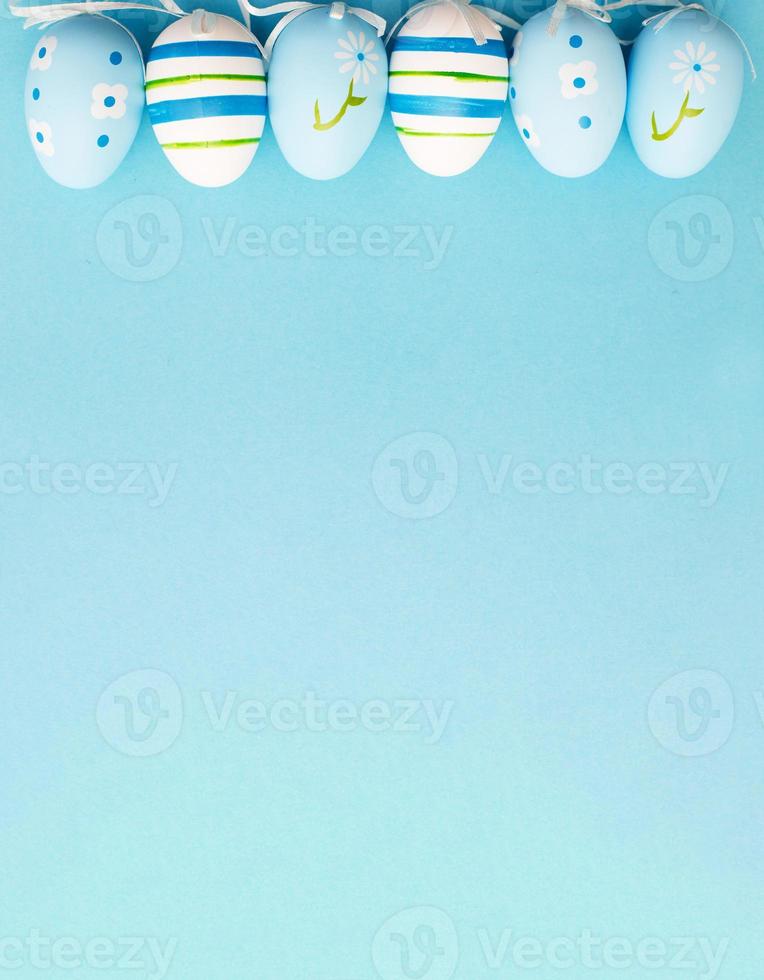 easter colorful handmade painted eggs on blue background with copy space. banner photo