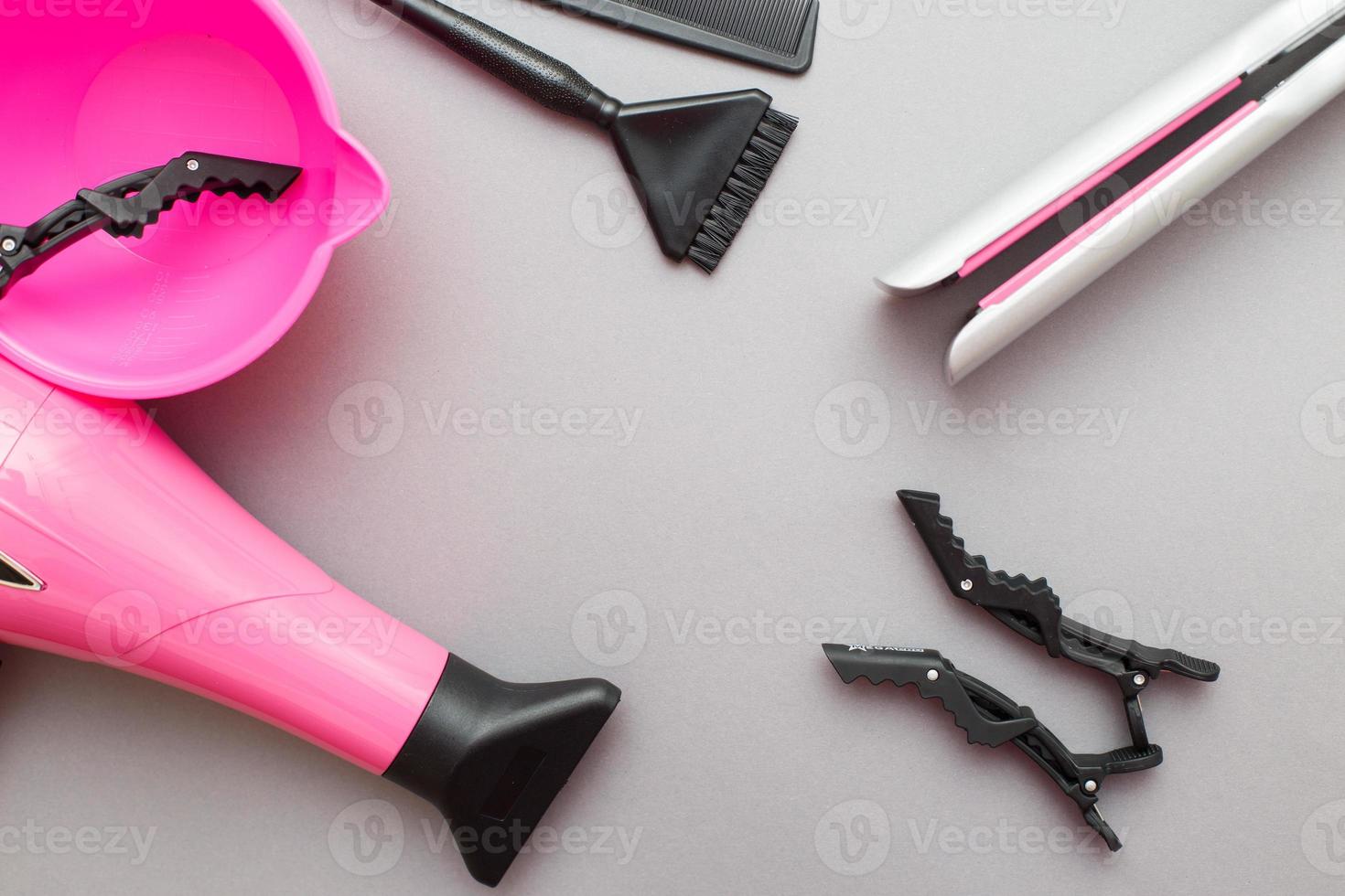 various hairdressing tools like hair dryer, comb on a gray background. beauty salon concept photo