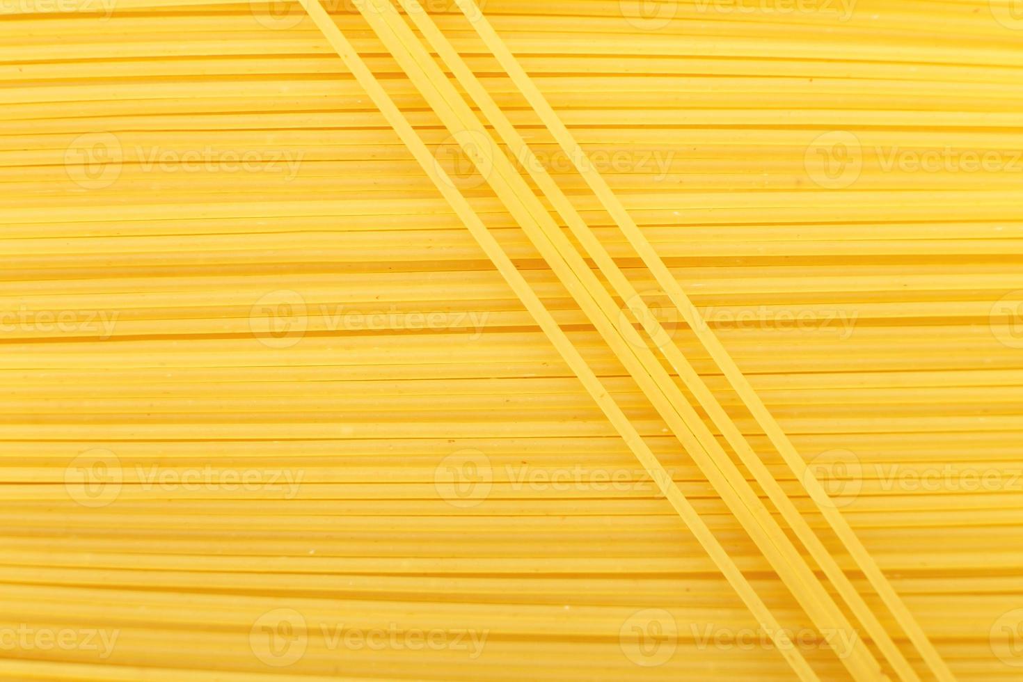 spaghetti yellow background close. raw pasta macro photo