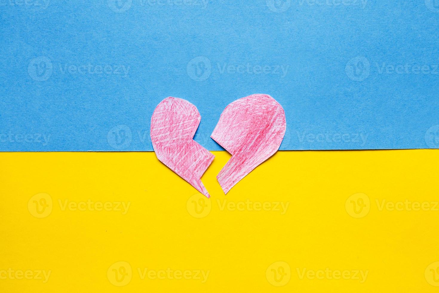 broken red heart on the ukrainian flag background photo