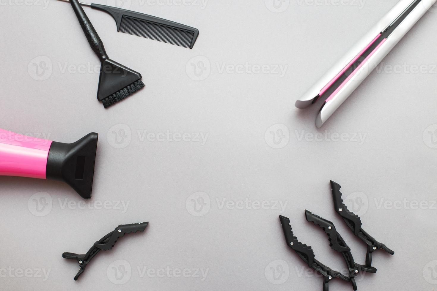 various hairdressing tools like hair dryer, comb on a gray background. beauty salon concept photo