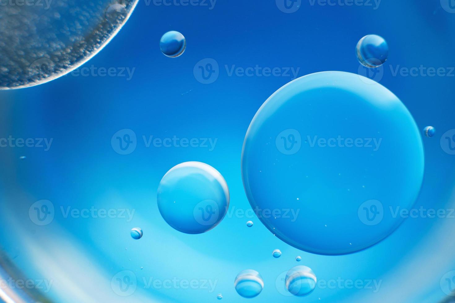 abstract light blue background with oil circles . bubbles of water close up . photo