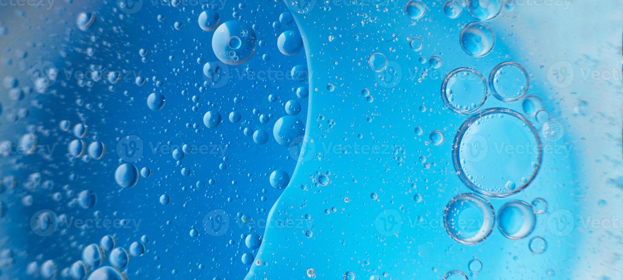 abstract light blue background with oil circles . bubbles of water close up . banner photo