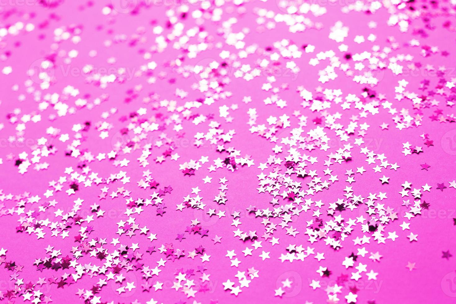 pink sparkles on a purple background. Festive backdrop for your projects. photo