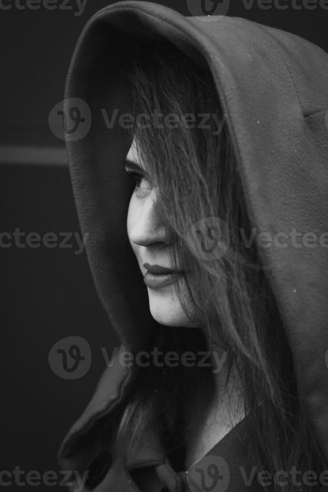 Close up pretty young woman wearing coat with hood monochrome portrait picture photo