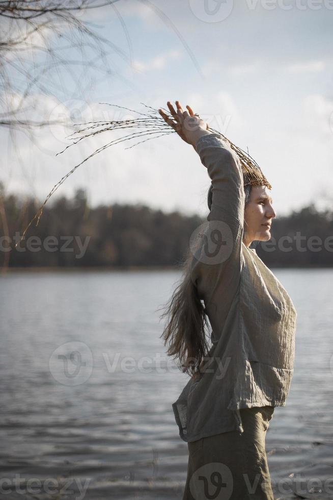 Close up authentic woman posing in front of lake in pagan outfit portrait picture photo