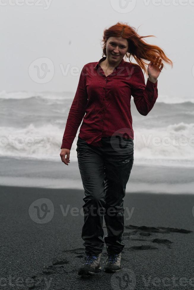 Woman with messy hair on black beach scenic photography photo