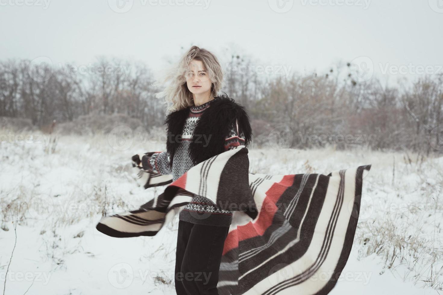Young woman with woolen plaid in winter field scenic photography photo