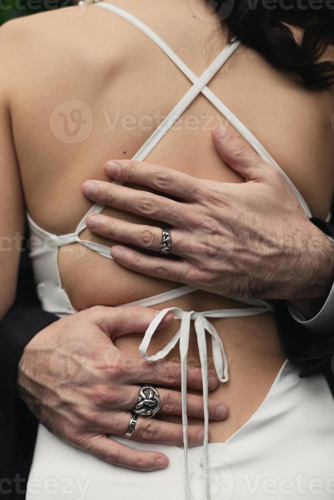 Close up masculine hands embracing bare woman back concept photo