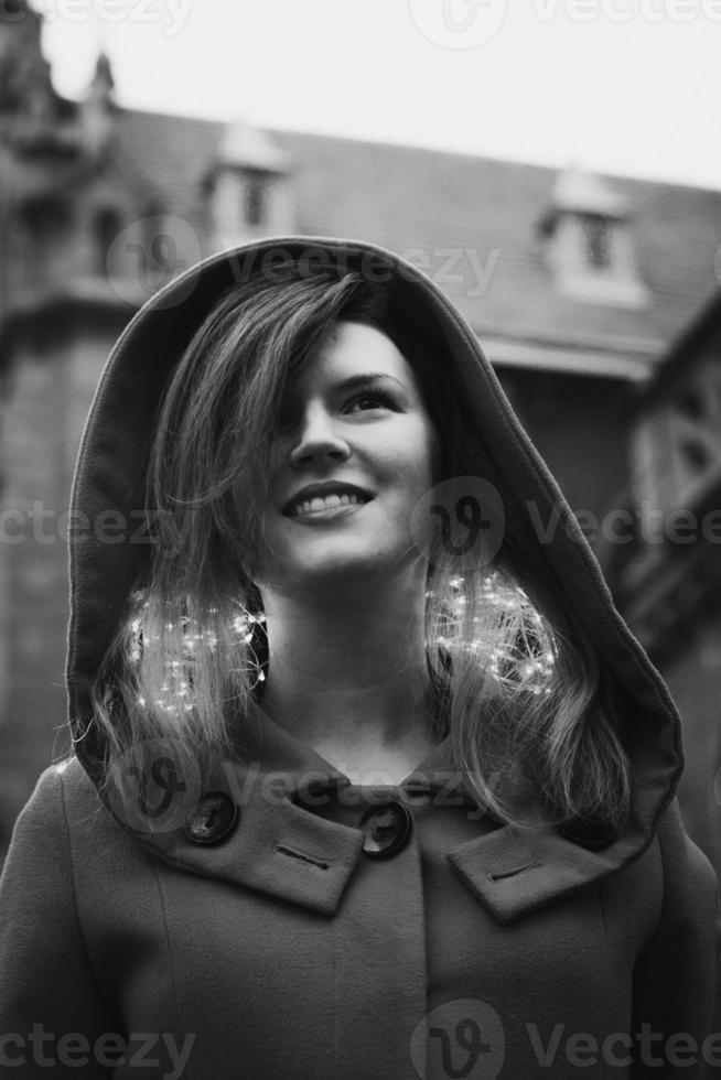 Close up woman with fairy lights on neck in town monochrome portrait picture photo