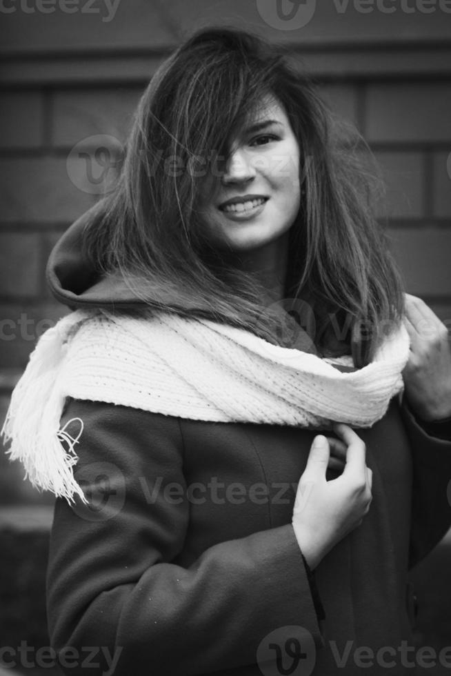 Close up smiling lady in coat with scarf monochrome portrait picture photo