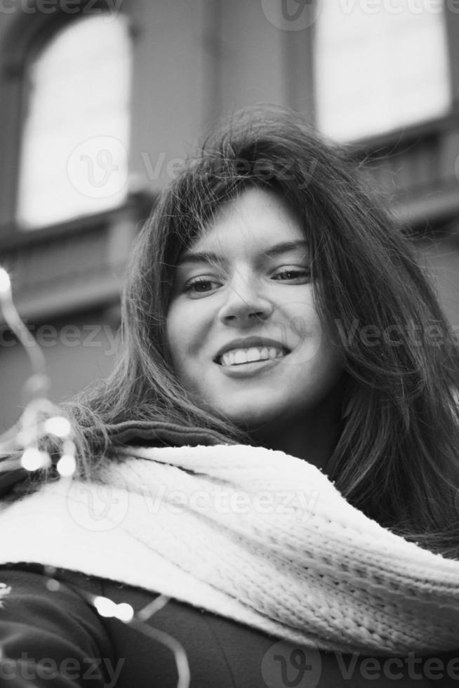 Close up attractive lady with scarf and fairy lights monochrome portrait picture photo