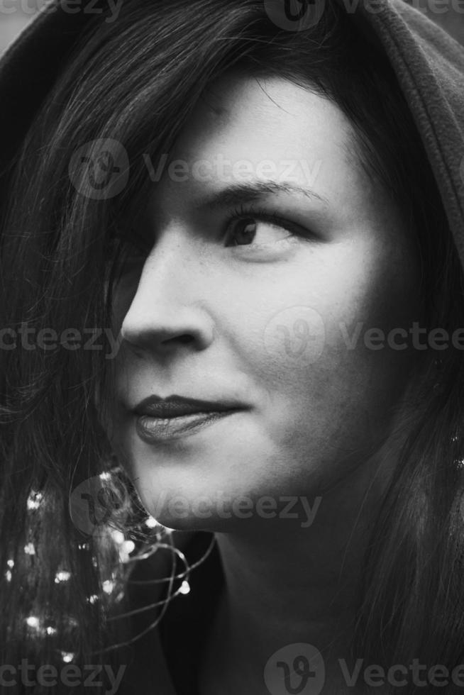 Close up positive woman with necklace of fairy lights monochrome portrait picture photo