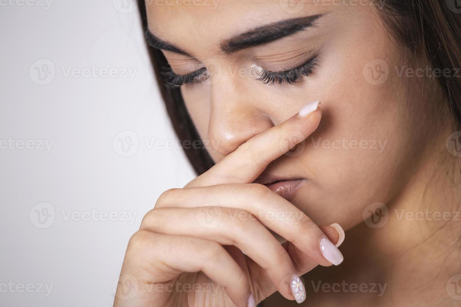 Collage of Young woman touches her nose - Concept showing avoid touch face to protect and prevent form covid-19, sars cov 2 or coronavirus outbreak or spreading. photo