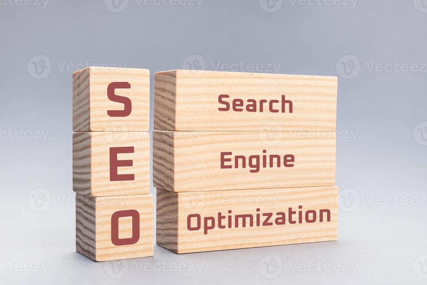 SEO Search Engine Optimization text on wooden blocks on gray background photo