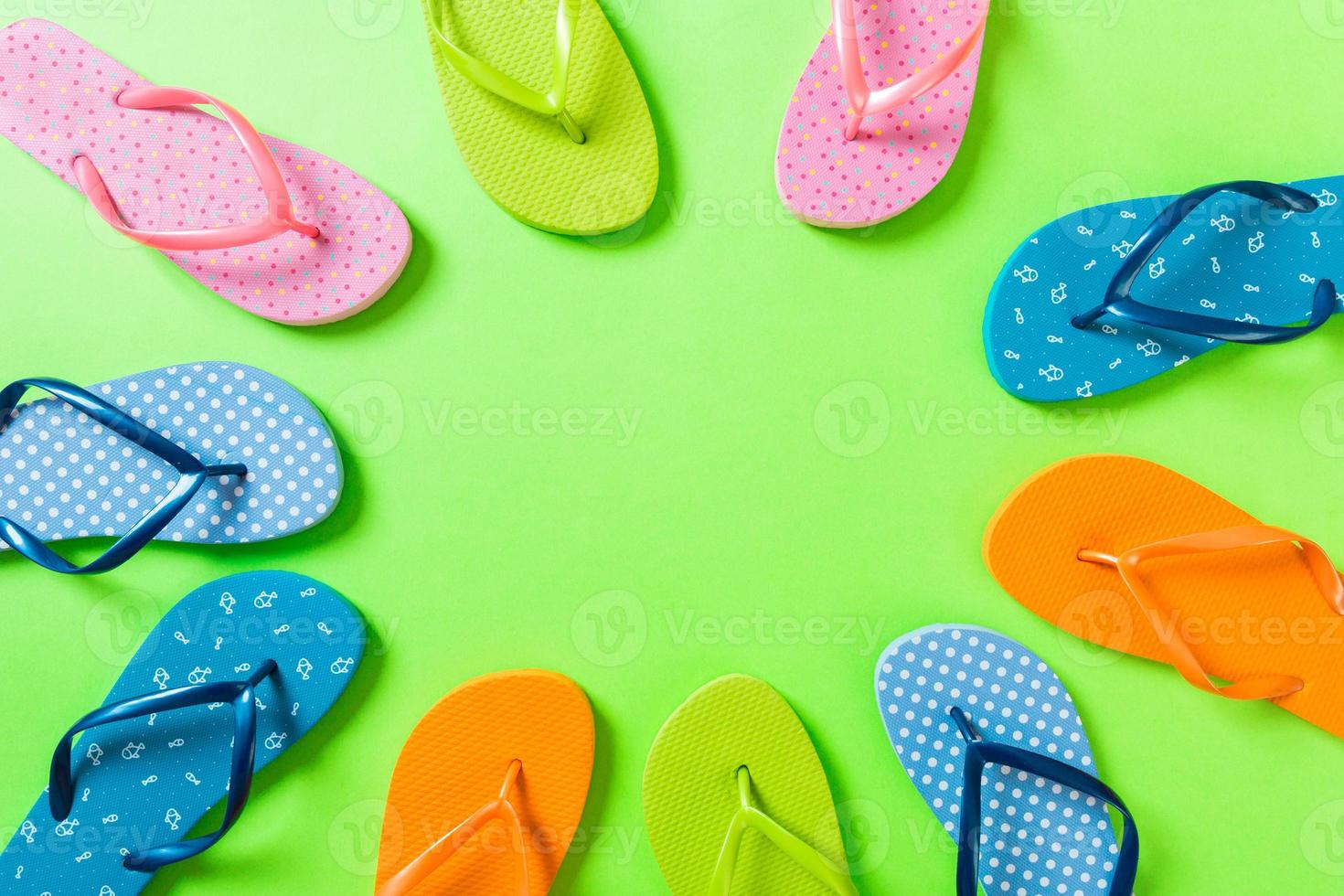 a lot of flip flop colored sandals, summer vacation on colored background, copy space top view photo