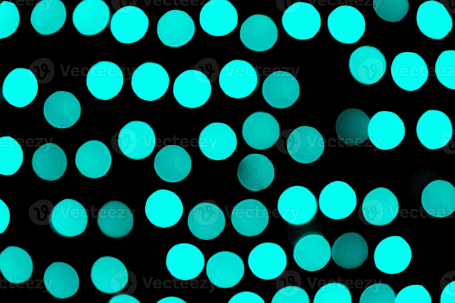 Unfocused abstract colourful bokeh black background. defocused and blurred many round blue light photo