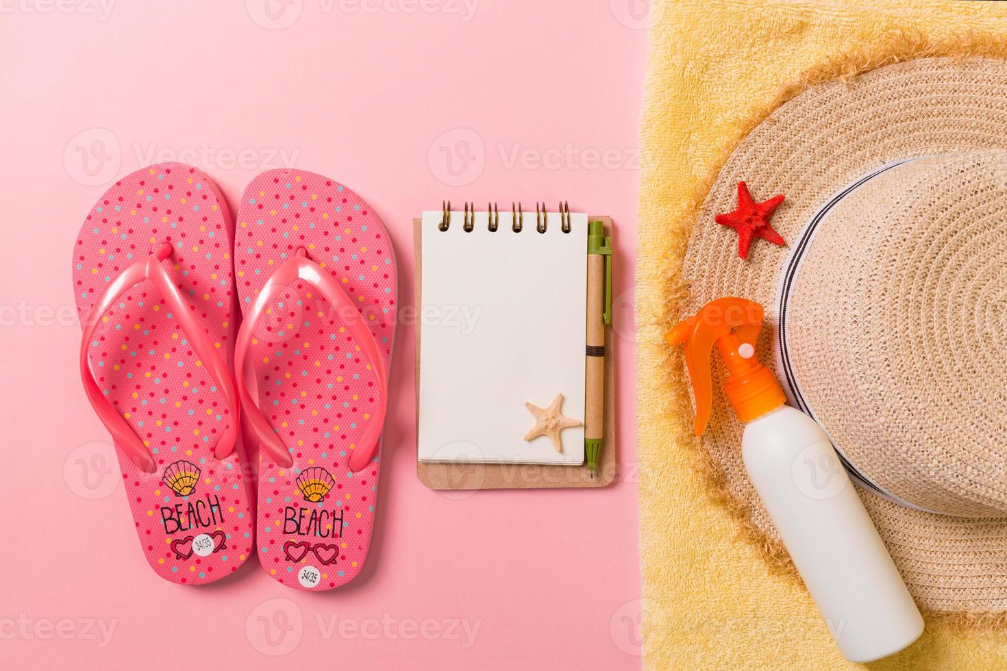 Flat lay, top view Travel concept. summer accessories with note paper and seashell on pink background photo