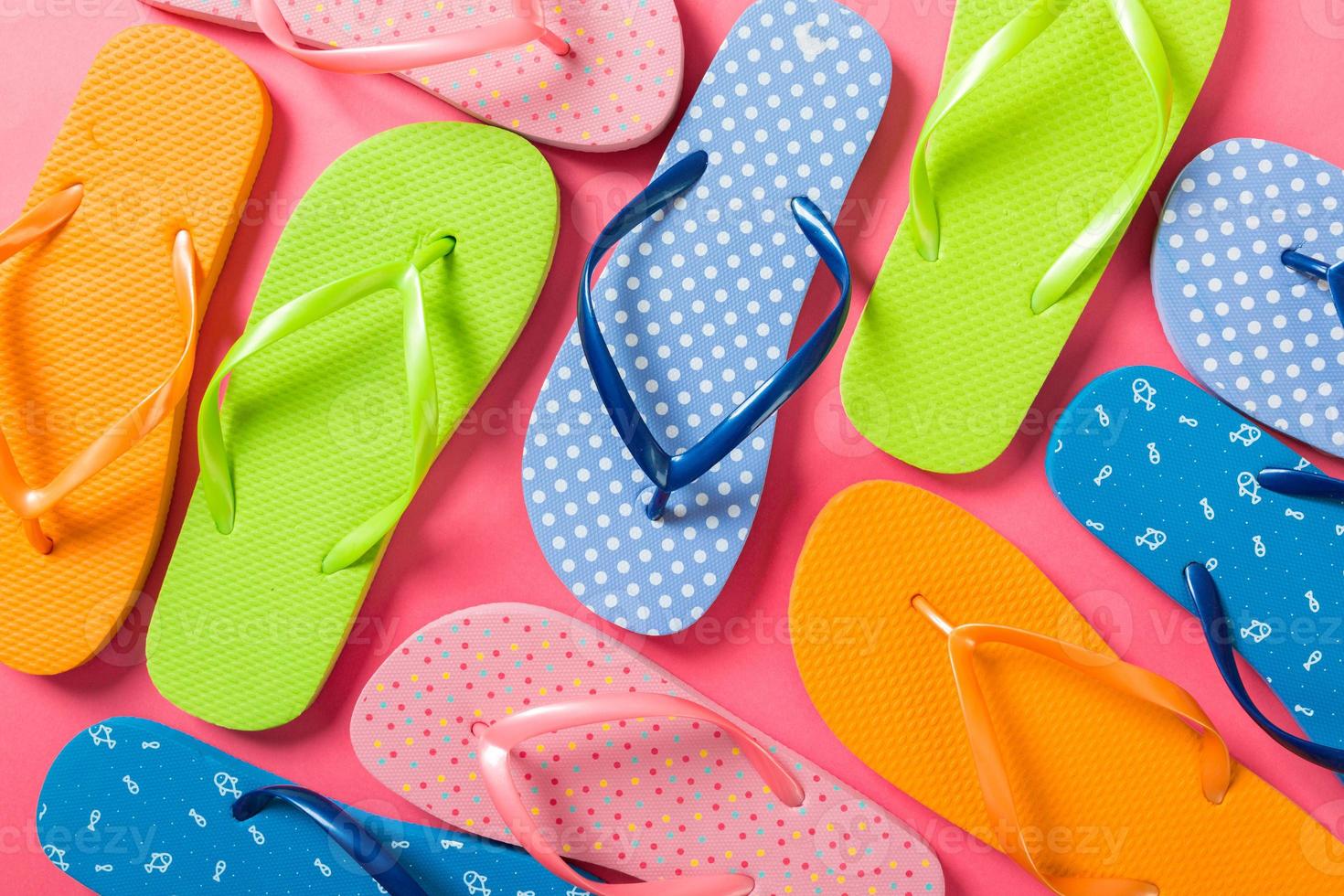 a lot of flip flop colored sandals, summer vacation on colored background, copy space top view photo